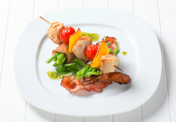 Chicken skewer and bacon-wrapped green beans