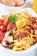 Scrambled eggs with mushrooms and sausage
