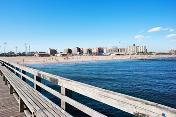 Pier with Coney Island beach in the background, New York City.