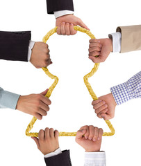 Hands holding rope forming keyhole