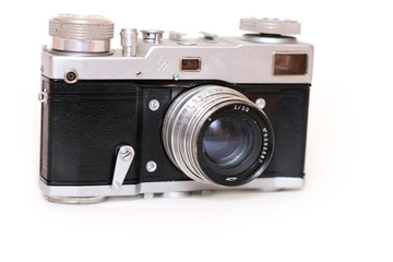 Front of an old film camera with lens