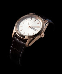 luxury watches with a leather strap on a black background
