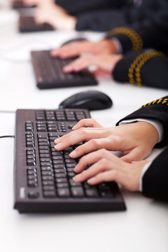 closeup of group of high school students typing on keyboard
