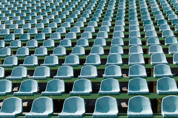 green seats for spectators in the stadium