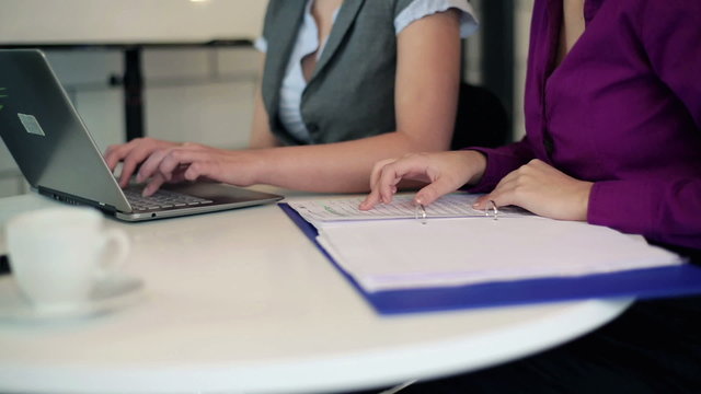 Businesswomen hands typing on notebook computer in the office