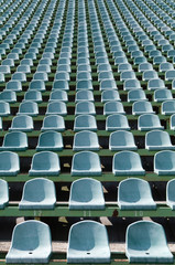 green seats for spectators in the stadium