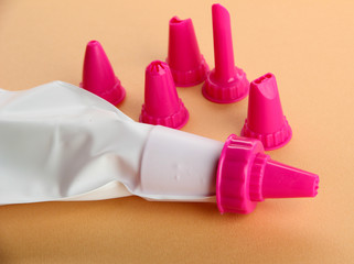 confectionery bag and replaceable nozzles, on orange background