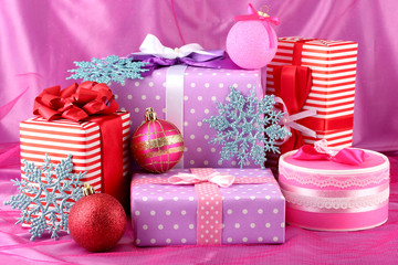 Colorful purple, red and pink gifts with Christmas balls and