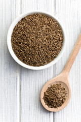 cumin seeds in wooden spoon
