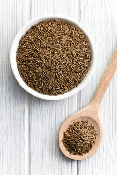 cumin seeds in wooden spoon