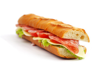 Long sandwich with  salami tomatoes isolated on white