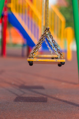 Fototapeta premium Empty chain swings on summer kids playground