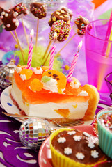cake with three candles on birthday party table for child