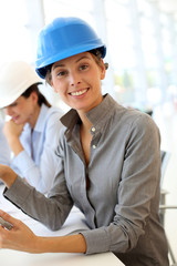 Architect with security helmet using electronic tablet