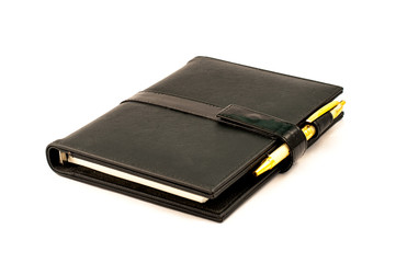 Black note book with ballpoint pen