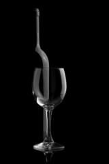 Elegant wine bottle and wine glass in a black background