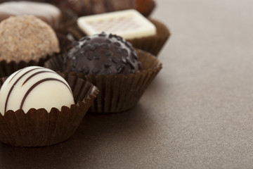 Assorted gourmet chocolate bonbons in paper cups
