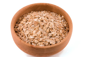 A bowl of oat flakes on white
