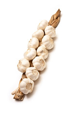 String of garlic bulbs isolated on a white studio background.