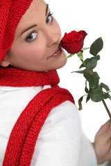 Woman holding single red rose