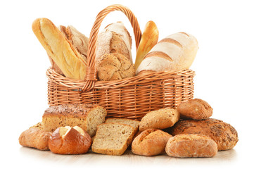 Bread and rolls in wicker basket isolated on white