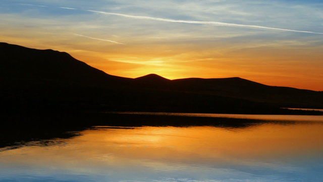 sunrise on morning lake with mountain