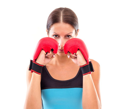 Pretty girl in boxing gloves pose, isolated on white