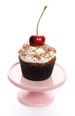 Cupcake with whipped cream and cherry