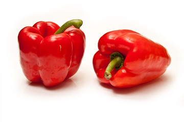 Red bell peppers on a  white studio background.