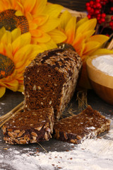 Rye bread on wooden table on wooden background close-up