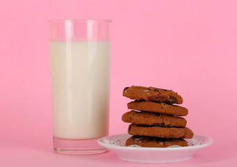 Glass of fresh new milk on pink background