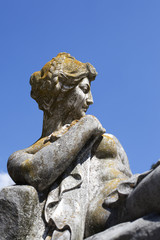 Fototapeta na wymiar old statue against blue sky