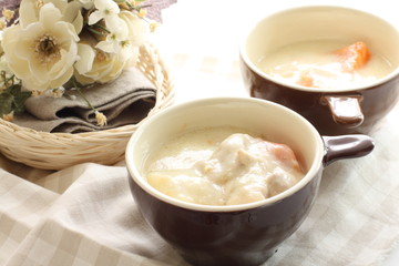 chicken and vegetable stew in soup cup with flower