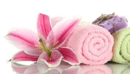 towels with beautiful pink lily and soap, isolated on white