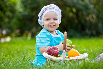 cute baby girl sitting ion the grass