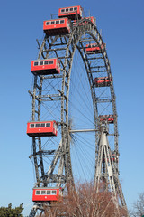Fototapeta premium ferris wheel with red cabines in Prater park in Vienna, Austria