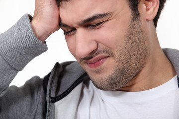 Man suffering from a throbbing headache