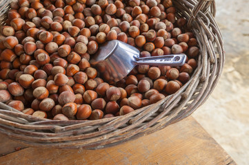 Hazelnut or filberts in a basket with metal scoop
