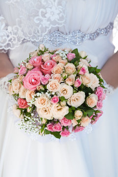 bouquet of pink roses in the bride's hands
