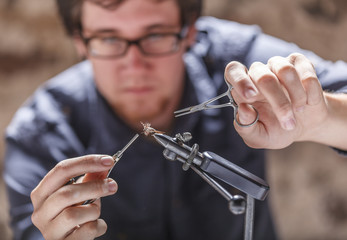 Man tying fly for fly fishing
