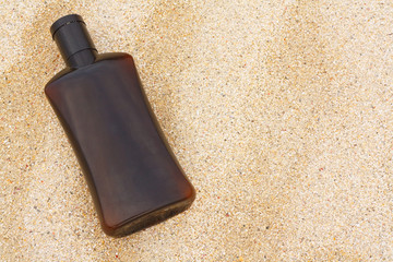 sun tan oil on sand