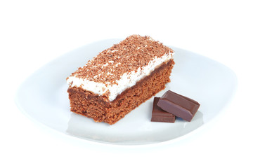 Tart cake on a plate with chocolate pieces.