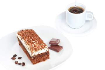 Breakfast of cake pieces of chocolate and coffee. On a white bac