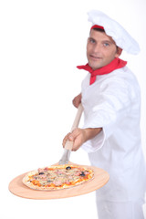 Pizza chef with a wooden peel