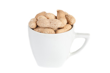 Peanuts in a white cup against a white background.