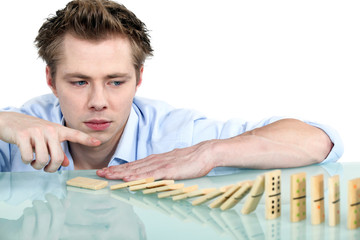 Man playing with dominoes