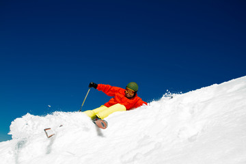 Freeride in fresh powder snow - man skiing downhill