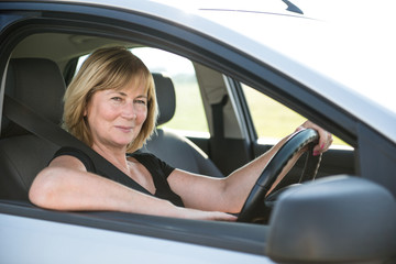 Fototapeta na wymiar Portrait of senior woman in car