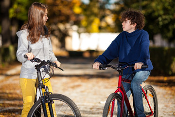 Urban biking - teens riding bikes in city