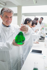 Fototapeta premium Chemist holding beaker